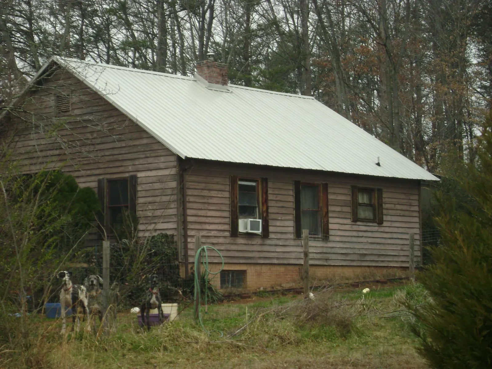 White metal roof on an old wood sided farmhouse, from a Asphalt Shingle Roof Repair job in Stewart